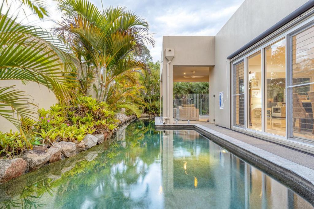Pelican Waters House | Luxury resort style villa pool by Custom Bnb Hosting