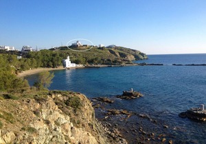 Windmill and houses by the sea / Stavros Bay