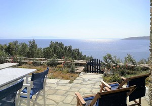 Windmill and houses by the sea / Stavros Bay