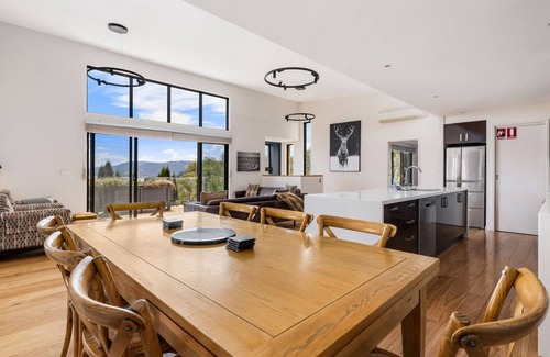 East Jindabyne House | Moongate with beautifully styled, open plan living with panoramic views over Lake Jindabyne