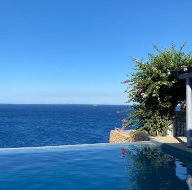 Waterfront villa "Afros" with a pool, direct access to the sea and a small beach in Koundouros